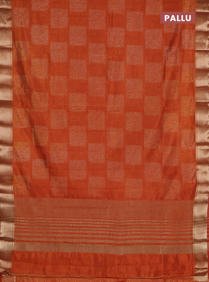 Semi raw silk saree rust shade with allover box type butta prints and zari woven border