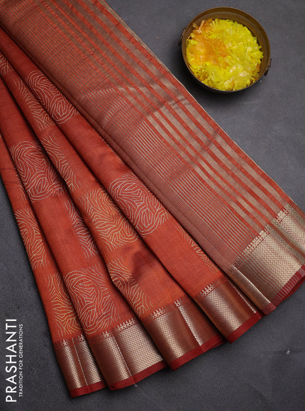 Semi raw silk saree rust shade with allover box type butta prints and zari woven border