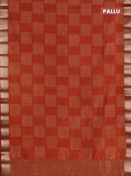 Semi raw silk saree rust shade with allover box type butta prints and zari woven border