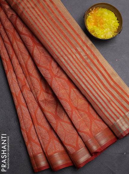 Semi raw silk saree rust shade with allover geometric prints and zari woven border
