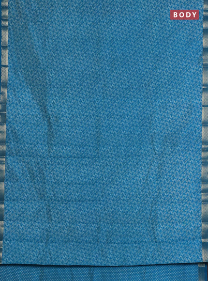 Semi raw silk saree teal blue with allover geometric prints and zari woven border
