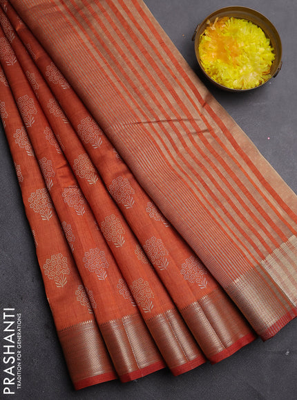 Semi raw silk saree rust shade with allover floral butta prints and zari woven border