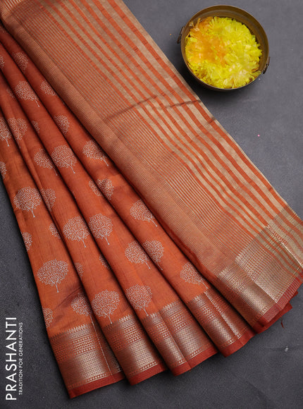 Semi raw silk saree rust shade with allover butta prints and zari woven border