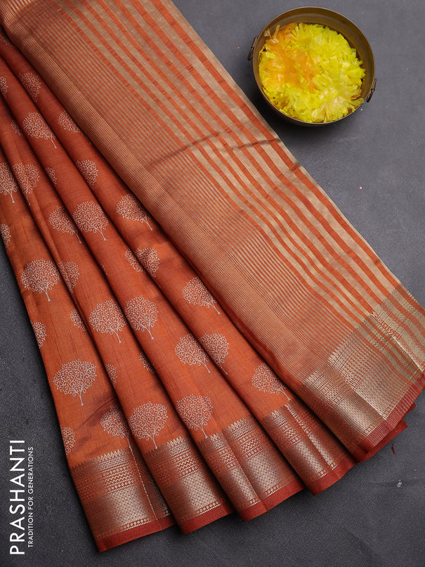 Semi raw silk saree rust shade with allover butta prints and zari woven border