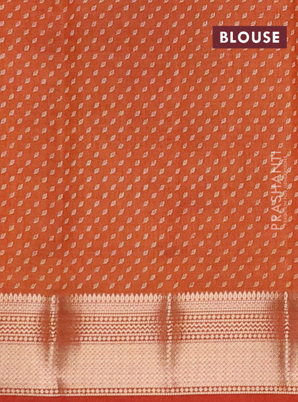 Semi raw silk saree rust shade with allover butta prints and zari woven border