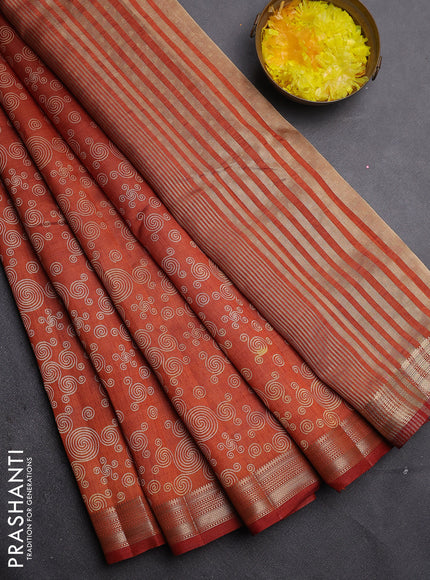 Semi raw silk saree rust shade with allover geometric prints and zari woven border