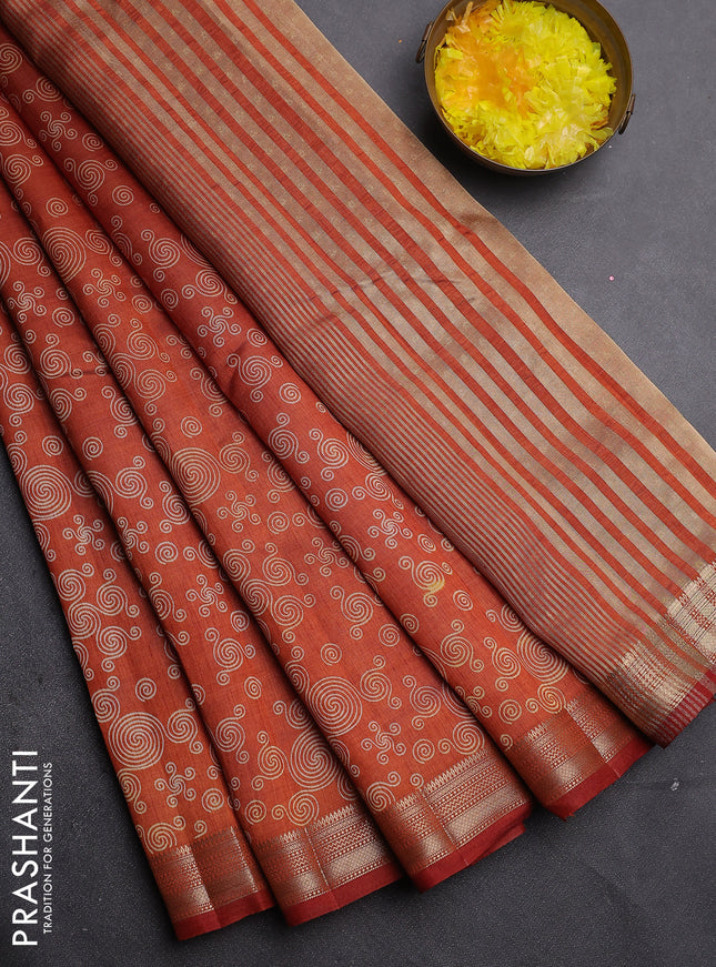 Semi raw silk saree rust shade with allover geometric prints and zari woven border