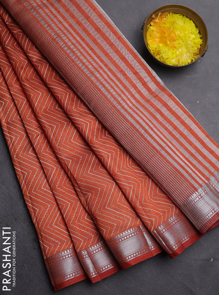 Semi raw silk saree rust shade with allover zigzag prints and zari woven border