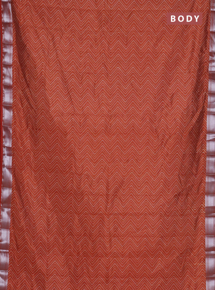 Semi raw silk saree rust shade with allover zigzag prints and zari woven border