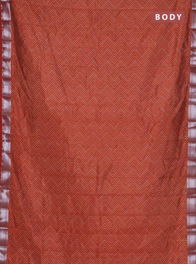 Semi raw silk saree rust shade with allover zigzag prints and zari woven border