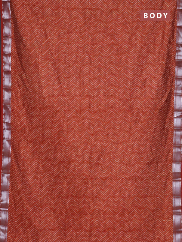 Semi raw silk saree rust shade with allover zigzag prints and zari woven border