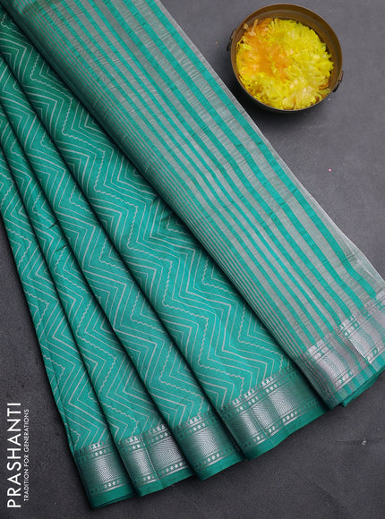 Semi raw silk saree teal blue with allover zigzag prints and zari woven border