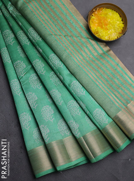 Semi raw silk saree light green with allover floral prints and zari woven border