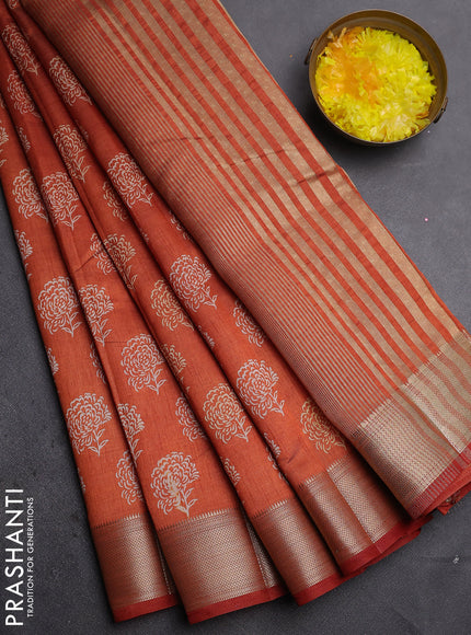 Semi raw silk saree rust shade with allover floral prints and zari woven border