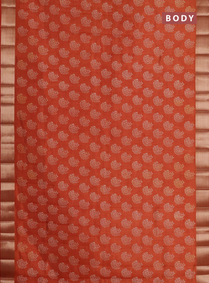 Semi raw silk saree rust shade with allover floral prints and zari woven border