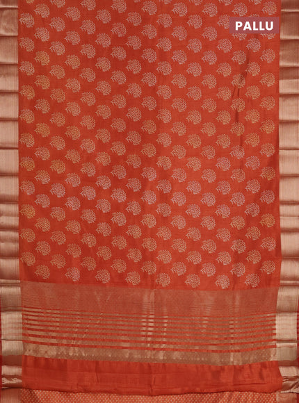 Semi raw silk saree rust shade with allover floral prints and zari woven border