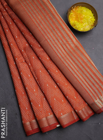 Semi raw silk saree rust shade with allover zigzag prints and zari woven border