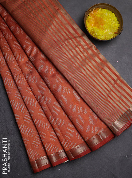 Semi raw silk saree rust shade with allover butta prints and zari woven border