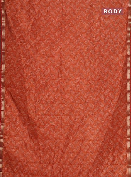 Semi raw silk saree rust shade with allover butta prints and zari woven border