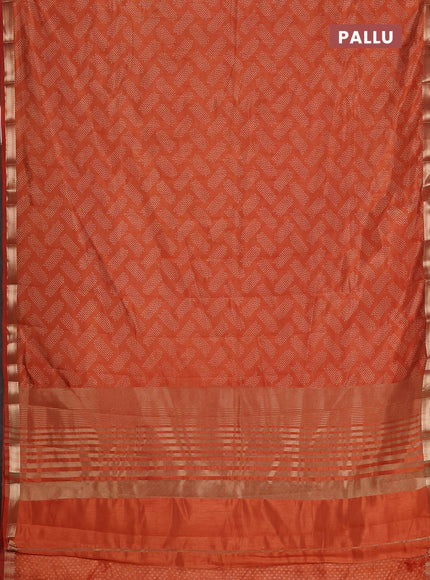 Semi raw silk saree rust shade with allover butta prints and zari woven border