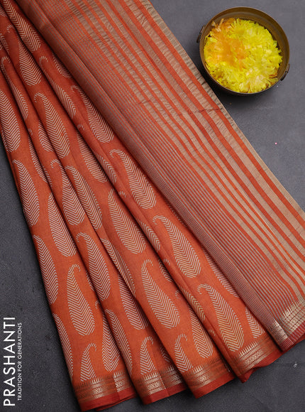 Semi raw silk saree rust shade with allover paisley prints and zari woven border
