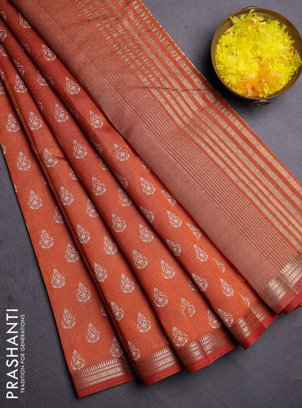 Semi raw silk saree rust shade with allover butta prints and zari woven border