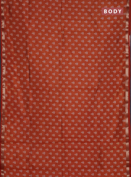 Semi raw silk saree rust shade with allover butta prints and zari woven border