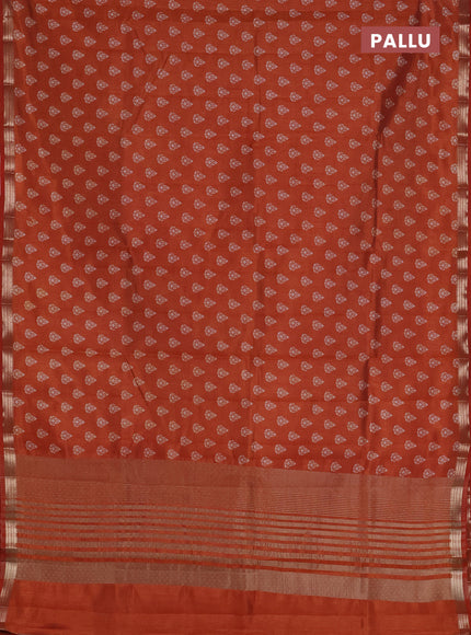 Semi raw silk saree rust shade with allover butta prints and zari woven border