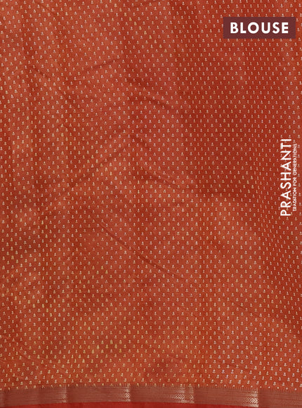 Semi raw silk saree rust shade with allover butta prints and zari woven border