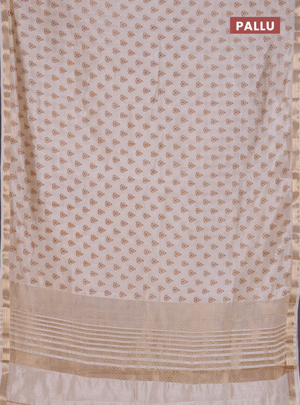 Semi raw silk saree off white with allover butta prints and zari woven border