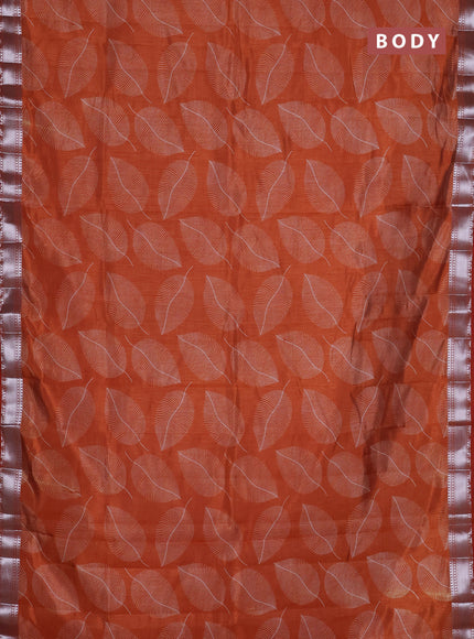 Semi raw silk saree rust shade with allover leaf butta prints and zari woven border