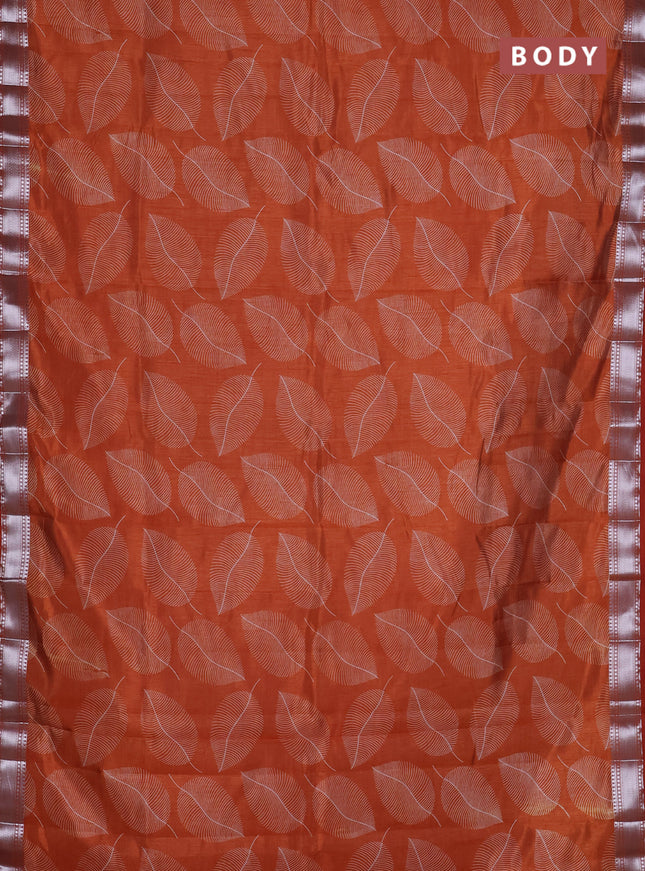 Semi raw silk saree rust shade with allover leaf butta prints and zari woven border