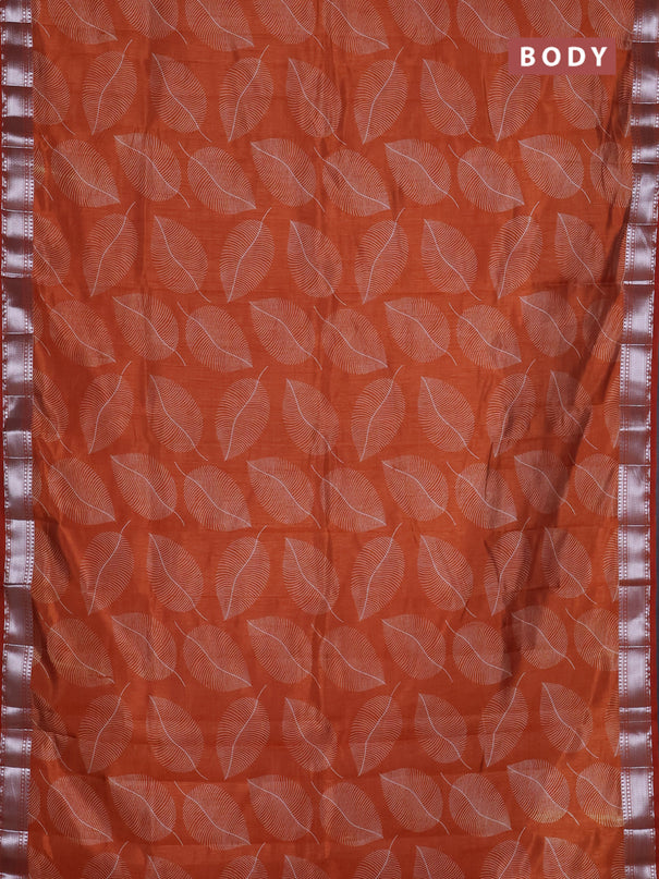 Semi raw silk saree rust shade with allover leaf butta prints and zari woven border