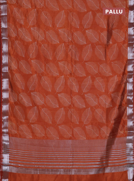 Semi raw silk saree rust shade with allover leaf butta prints and zari woven border