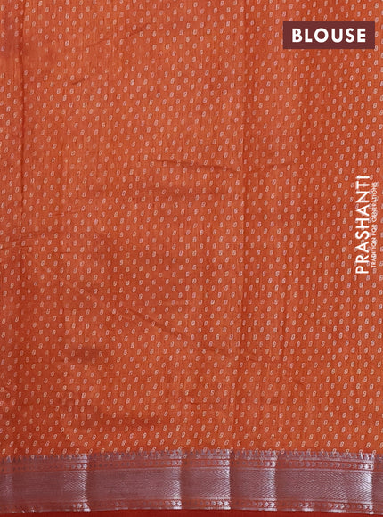 Semi raw silk saree rust shade with allover leaf butta prints and zari woven border