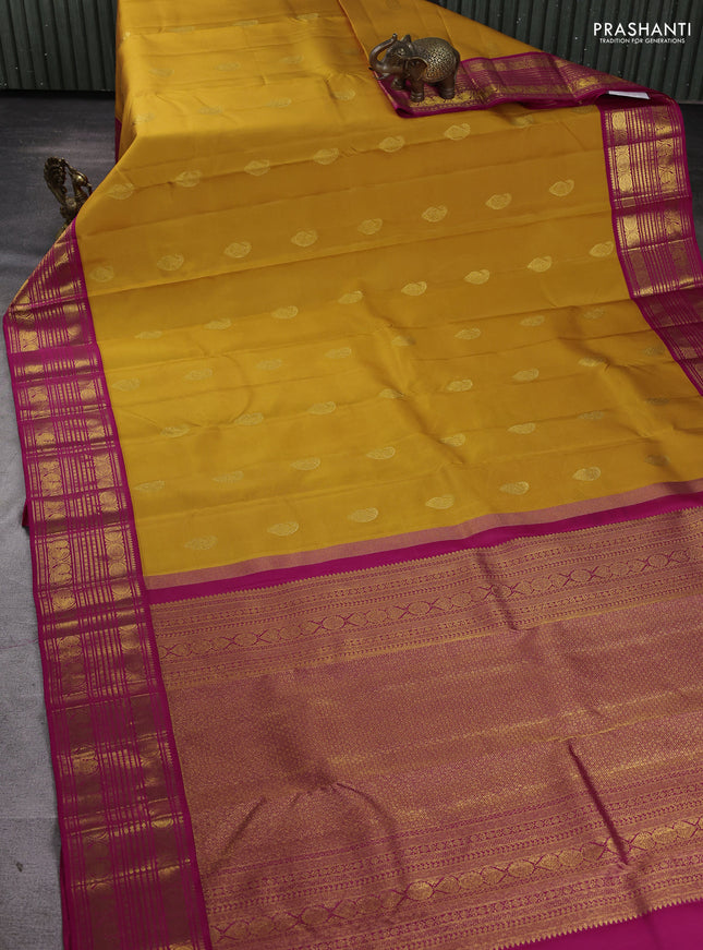 Pure kanchipuram silk saree mango yellow and pink with paisley zari woven buttas and zari woven korvai border