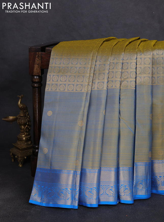 Pure kanchipuram silk saree dual shade of bluish yellow and cs blue with allover zari brocade weaves and long zari woven butta border