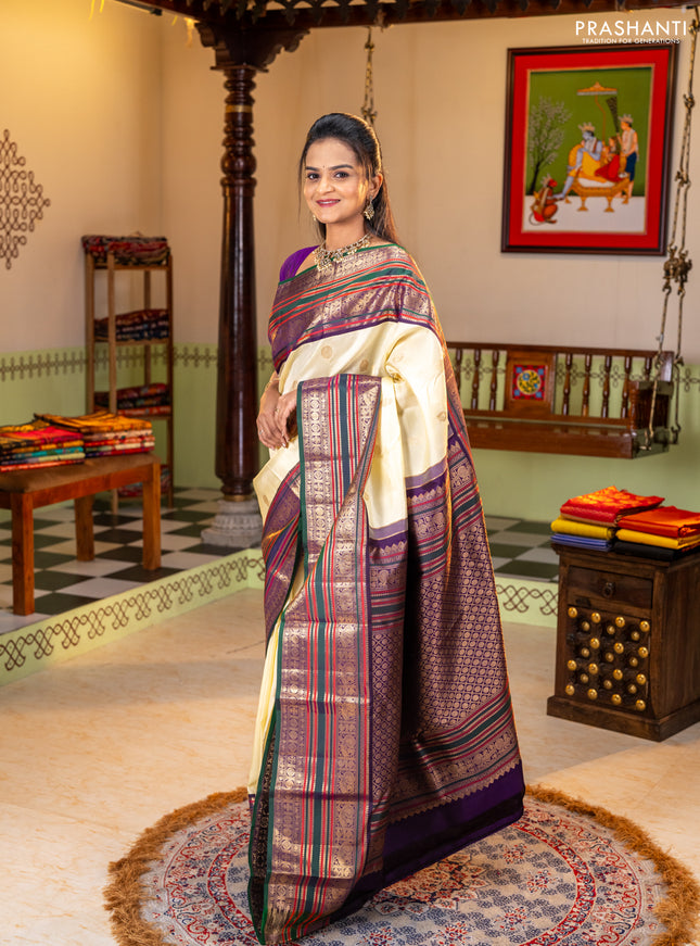 Pure kanchipuram silk saree cream and bottle green with zari woven buttas and long zari woven korvai border