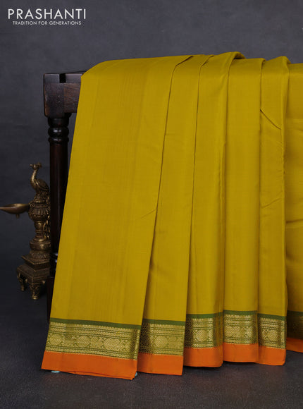 Pure kanchipuram silk saree yellow and orange with plain body and zari woven border