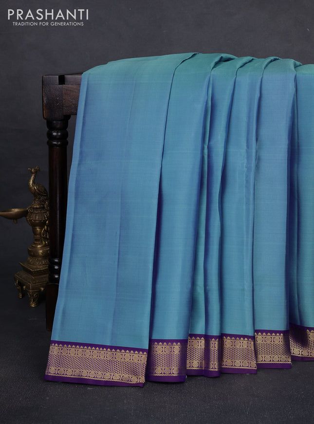 Pure kanchipuram silk saree blue shade and violet with plain body and zari woven border