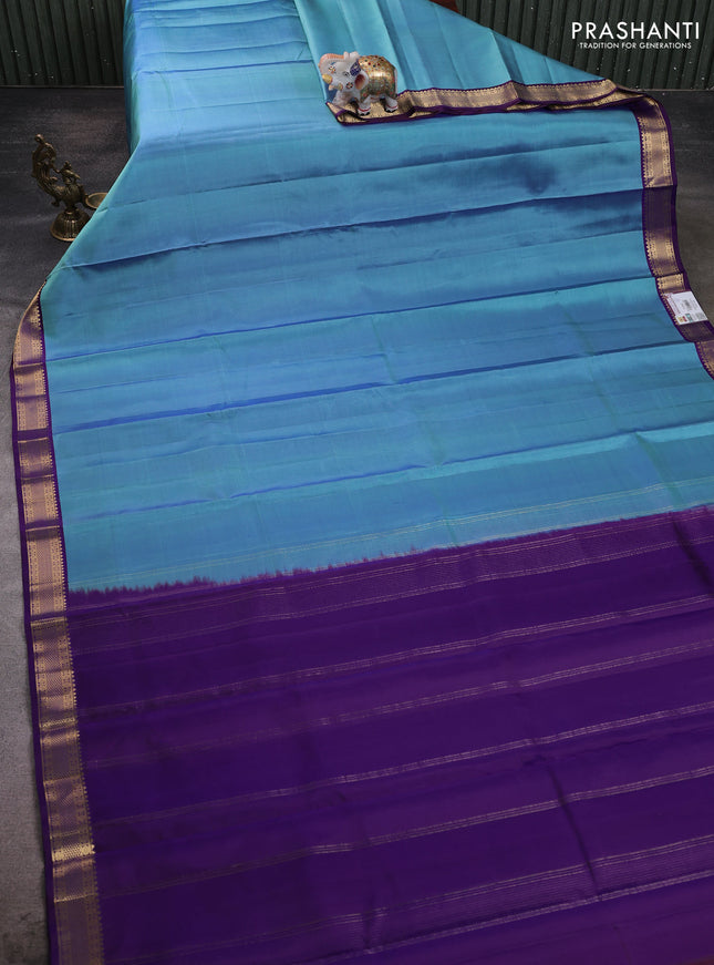 Pure kanchipuram silk saree blue shade and violet with plain body and zari woven border
