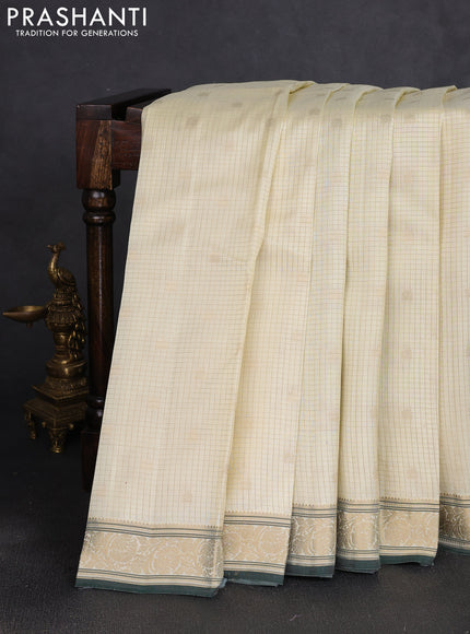 Pure kanchipuram silk saree cream and bottle green with allover zari small checks & buttas and zari woven border