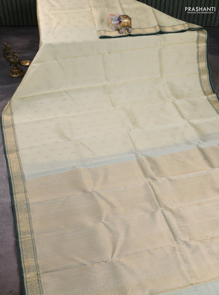 Pure kanchipuram silk saree cream and bottle green with allover zari small checks & buttas and zari woven border