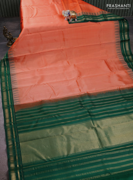 Pure kanchipuram silk saree peach orange and green with plain body and temple design zari woven border