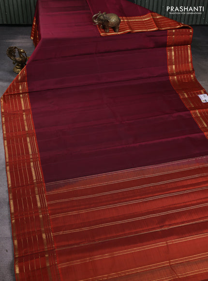 Pure kanchipuram silk saree wine shade and orange with plain body and zari woven border