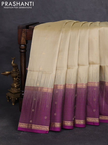 Pure soft silk saree beige and purple with allover zari woven buttas and long zari woven checked butta border