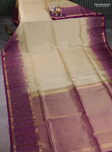 Pure soft silk saree beige and purple with allover zari woven buttas and long zari woven checked butta border