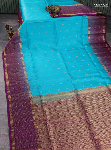 Pure soft silk saree teal blue and purple with allover zari woven buttas and long zari woven checked butta border