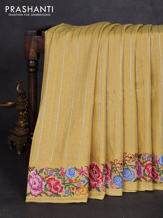 Semi tussar saree pale yellow with allover silver & zari stripe pattern and convent embroidery border