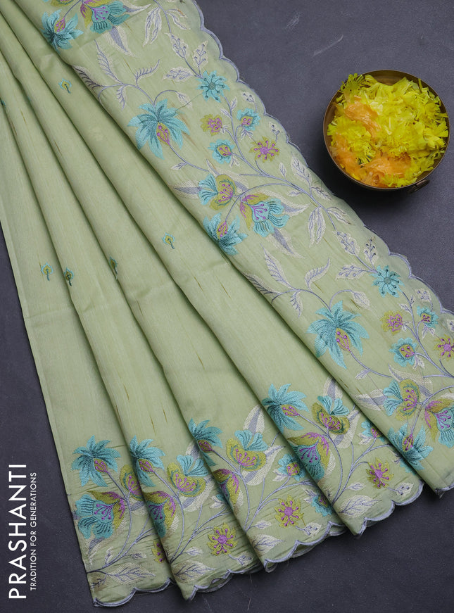 Semi raw silk saree pista green with embroidery buttas and floral embroidery border
